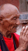 Tibetan man holding hands praying